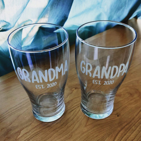 2 beer pint glasses engraved with matching Grandma and Grandpa text designs