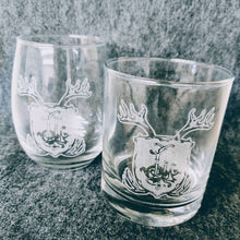 Load image into Gallery viewer, A whiskey glass and a stemless wine glass each engraved with a coat of arms
