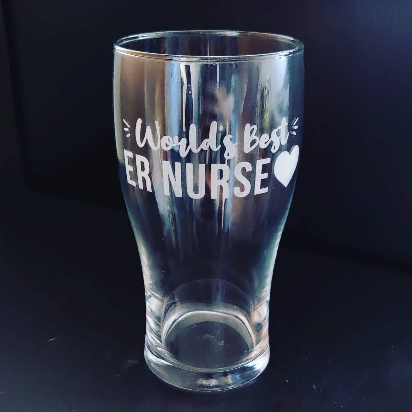 A pint glass engraved with World's Best ER Nurse