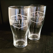 Load image into Gallery viewer, Two beer pint glasses that have the logo for Private Pews Brewing Company engraved on them
